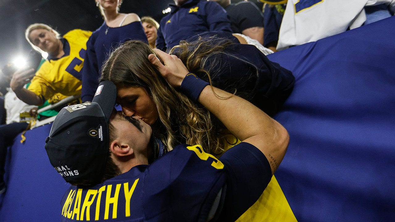 Michigan’s JJ McCarthy shares smooch with girlfriend after winning national championship