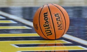 College basketball fan distracts opponent at free throw line by getting haircut in stands